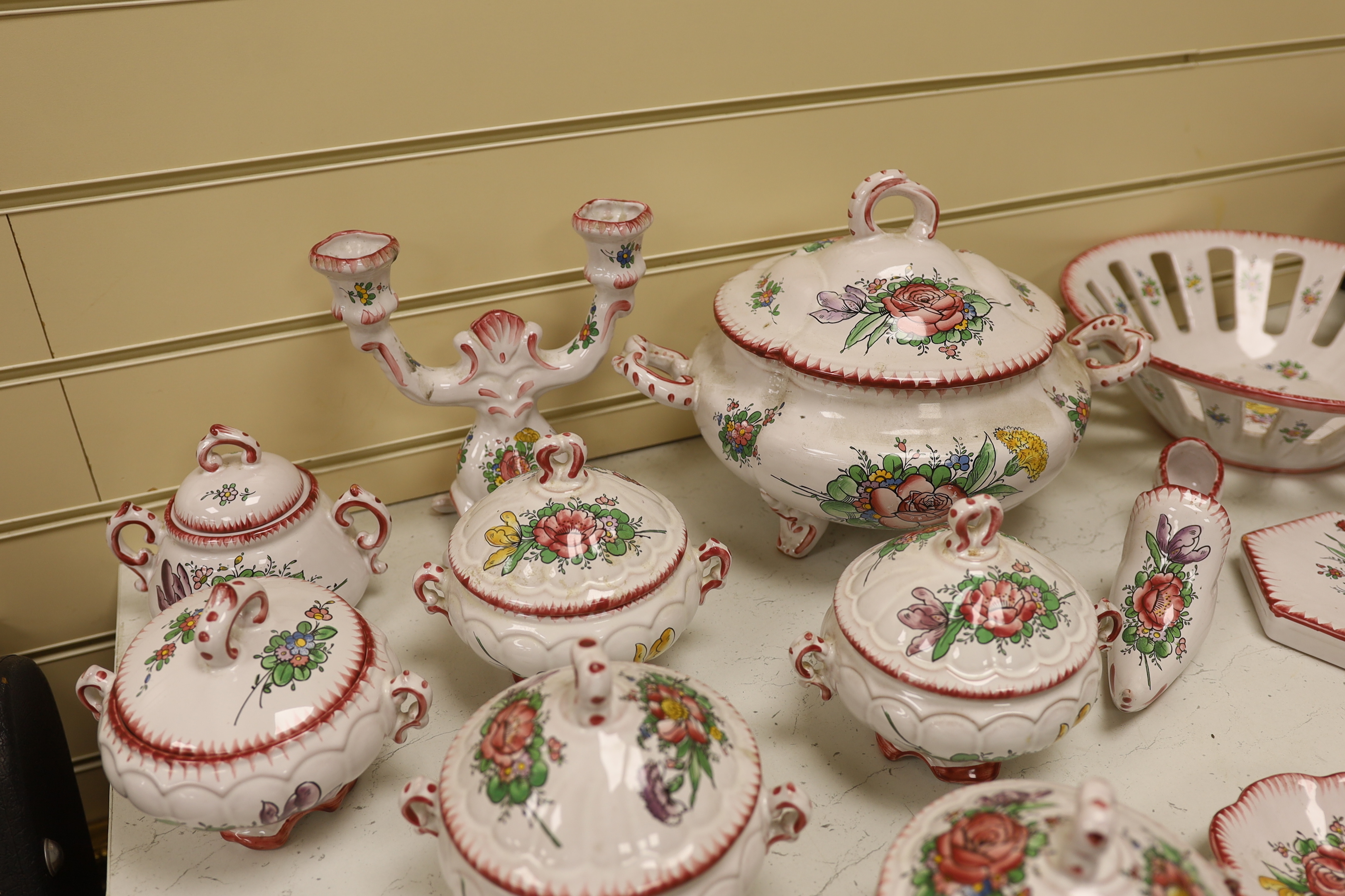 Le Renoleau Faiencerie D'Art, Angouleme, French faience tableware with floral decoration, including lidded serving pots, tureens, jugs, serving dishes, coasters, plates, candle stands, a candlestick, a water dispenser fo